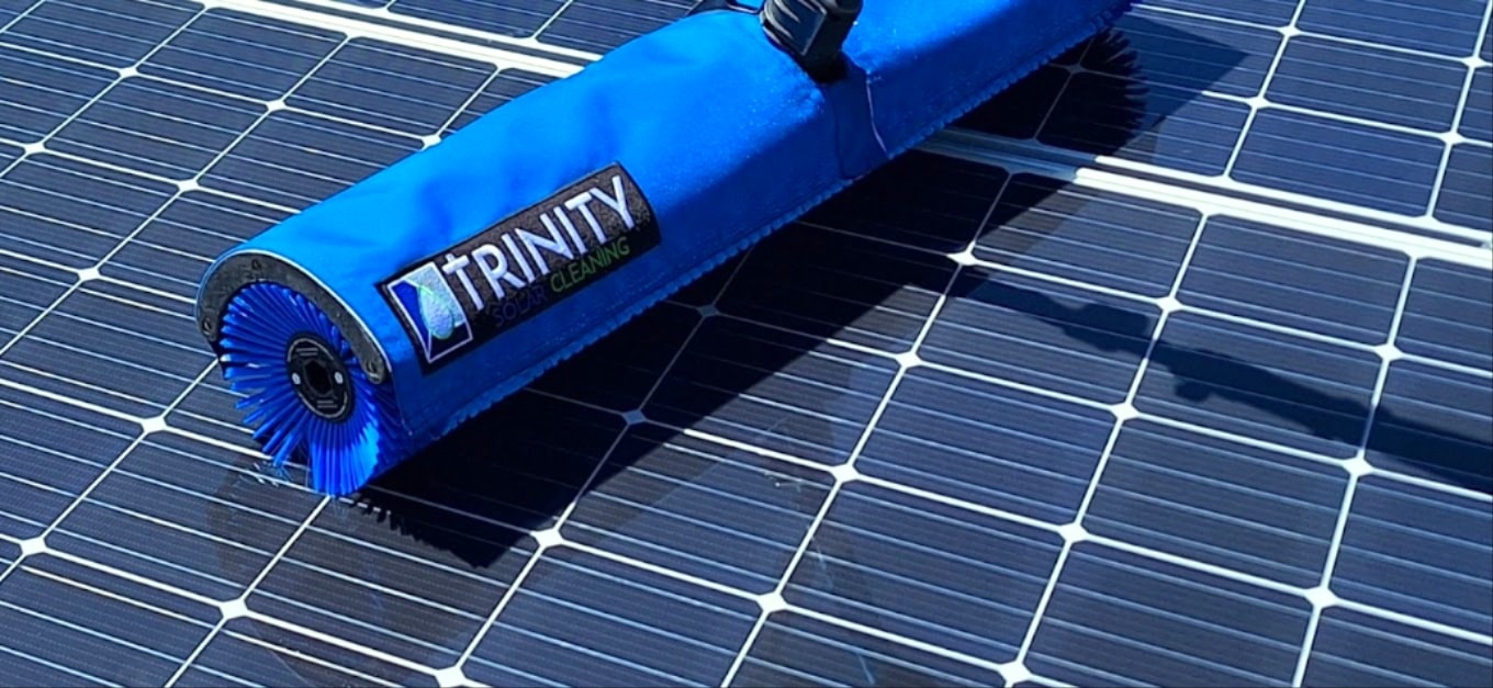 Solar panel cleaning technician on rooftop